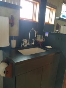 a kitchen counter with a sink and a mirror at The Inn at Newport Ranch in Fort Bragg