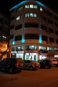 a tall building with cars parked in front of it at Hotel Kaya in Diyarbakır