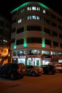 a tall building with cars parked in front of it at Hotel Kaya in Diyarbakır