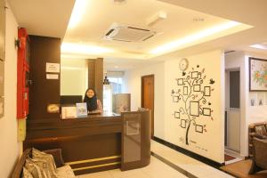 a woman standing at a counter in a salon at N K Hotel in Muar