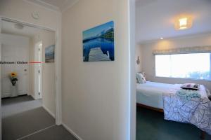 a bedroom with a bed and a large window at Harbour Heights in Tauranga
