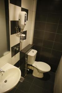 a bathroom with a toilet and a sink at N K Hotel in Muar