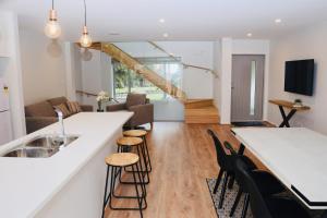 a kitchen and living room with a counter and chairs at Central Lake Hamilton in Hamilton