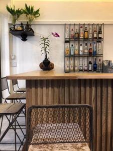 a bar with a shelf of alcohol bottles at Blue Chang House in Bangkok