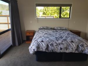 a bedroom with a large bed with a window at Bellhaven in Cromwell