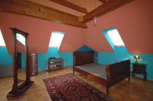 a bedroom with a bed and skylights in a attic at Wodne Ogrody in Dobczyce