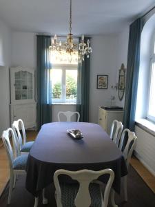 a dining room with a table and chairs at Villa Elfenstein in Bad Harzburg