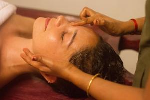 a woman getting her hair washed at a hair salon at Palm Trees Ayurvedic Heritage in Patnem +96 photos