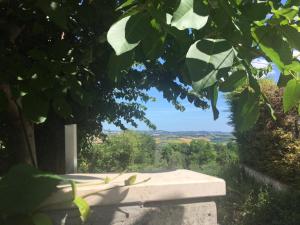 a stone bench with a view of a mountain at Eden Lilli B&B in La Pieve