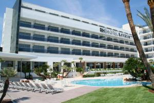 a hotel with a swimming pool in front of a building at RH Bayren Hotel & Spa 4* Sup in Gandía