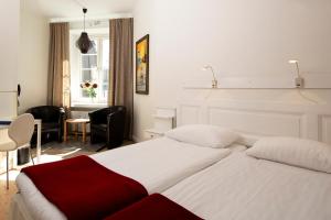 Postel nebo postele na pokoji v ubytování Hotel Emma