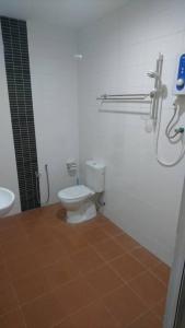 a bathroom with a toilet and a shower in it at Hotel Mill Road in Malacca