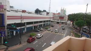 a city street with cars parked on the street at Hotel Mill Road in Malacca