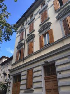 a white building with brown doors and windows at Centralissima mansarda . in Gorizia