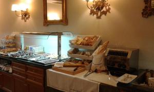 a bakery with a counter with a bunch of pastries at Parador de Santillana del Mar in Santillana del Mar