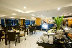 a restaurant with tables and chairs and a buffet at Kantary House Hotel, Bangkok in Bangkok
