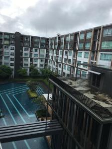 a large apartment building with a tennis court in front of it at D-condo mine in Kathu