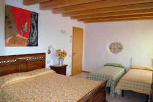 Posteľ alebo postele v izbe v ubytovaní Agriturismo Colombarola