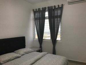 Schlafzimmer mit einem Bett und einem Fenster in der Unterkunft SINGGAH Putrajaya - 3 Bedrooms with Pool and KL View in Putrajaya