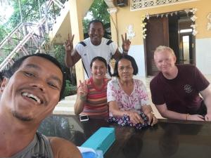 a group of people posing for a picture at a table at Bunyong Homestay in Siem Reap