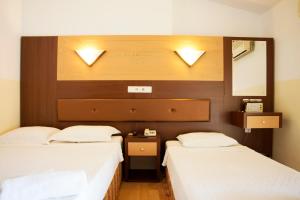 Postel nebo postele na pokoji v ubytování Wassermann Hotel
