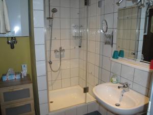 a bathroom with a shower with a sink and a shower at Bed & Kitchen Burgau in Burgau +36 photos