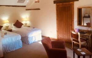 
A bed or beds in a room at Slapton Manor
