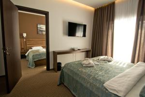 Postel nebo postele na pokoji v ubytování Sky Inn Batumi