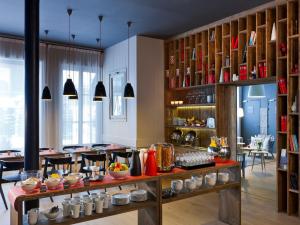 a restaurant with a counter with food on it at Le Faucigny - Hotel de Charme & SPA in Chamonix-Mont-Blanc