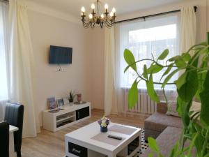 a living room with a couch and a table at Šiauliai Central Spot Apartment in Šiauliai