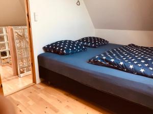 a bed in a room with two pillows on it at Centralt i Gentofte i 2 plan, ved S-Tog og busser in Gentofte