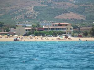 a beach with a group of people on the beach at Gramvoussa Bay in Kissamos