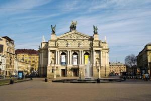 a large building with a fountain in front of it at Apartment on Svobody Avenue 47 in Lviv