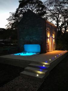 a small house with a blue lit up room at The Hand at Llanarmon in Llanarmon Dyffryn-Ceiriog