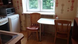 a kitchen with a table and two chairs and a microwave at Harmony Life Two-room apartment in Riga in Riga