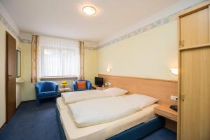 Een bed of bedden in een kamer bij Hotel Rebstock