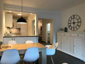 a kitchen and dining room with a table and chairs at City Apartment 221 in Merano