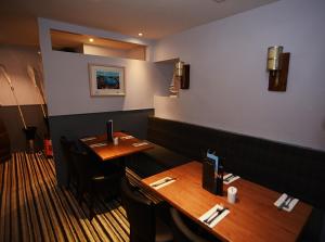 a room with a table, chairs, and a coffee table at Firth Hotel & Restaurant in Lossiemouth