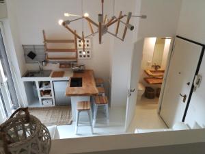 a small kitchen with a table and a dining room at BED and BIKE - BERGAMO Old Town in Bergamo +2 photos