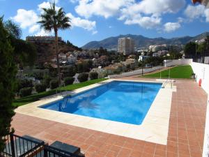 a swimming pool with a view of the city at Lomas de Mena in Benalmádena