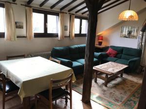 a living room with a couch and a table at Vennhaus 33 pers in Waimes