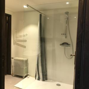 a shower with a glass door in a bathroom at Vennhaus 33 pers in Waimes +70 photos