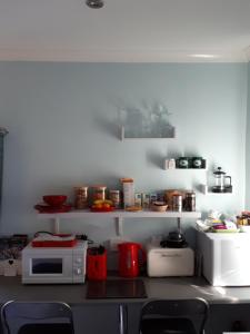 a kitchen with a counter with a microwave and appliances at Santi Bhavana Bed & Breakfast in Westbury
