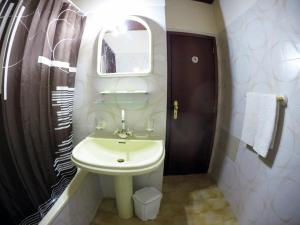 a bathroom with a white sink and a mirror at Hotel GORDON in Funchal