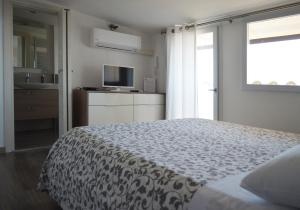 a bedroom with a bed and a tv and a window at Casa di Cecè in Agrigento