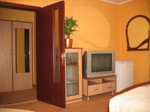 a living room with a tv and a bedroom at Premier Club in Chernivtsi