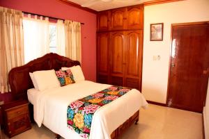 a bedroom with a bed and a dresser at Departamentos K&B in Playa del Carmen