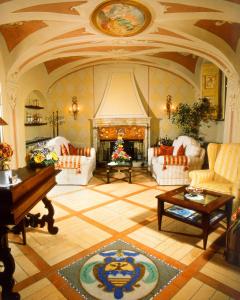 un grand salon avec une cheminée et un piano dans l'établissement La Contrada dei Monti, à Orta San Giulio