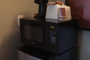 a microwave sitting on top of a counter at Cozy Inn in Costa Mesa