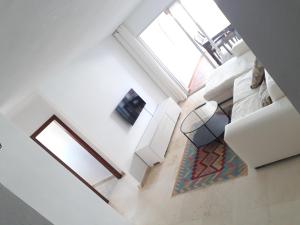 an overhead view of a living room with white furniture at urbanización puerto paraiso in Estepona